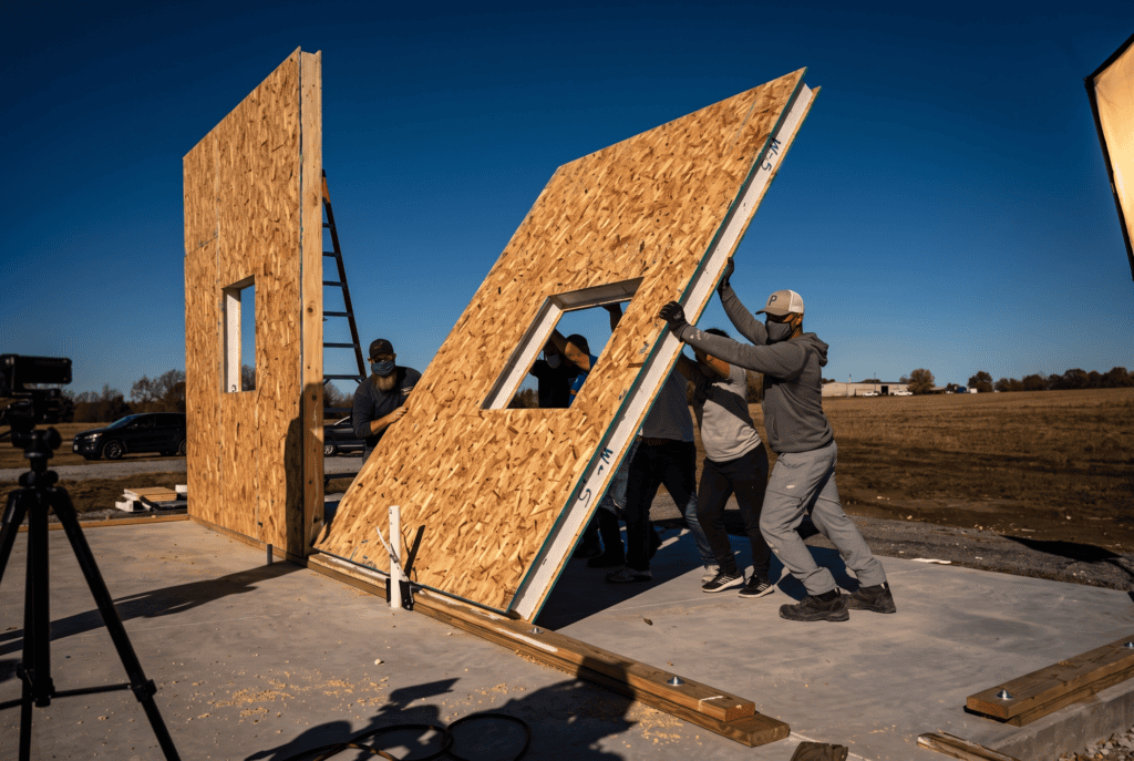 Structural insulated panels (SIPs) being raised into place on a Struxa home